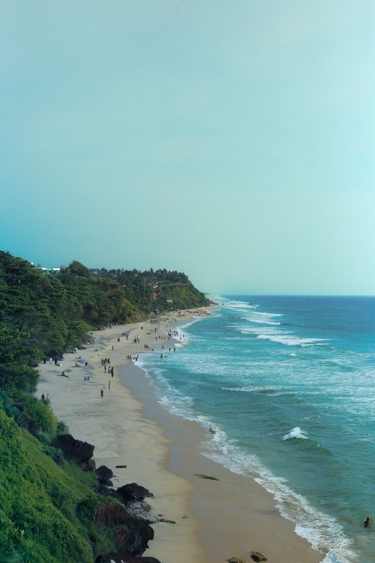 This may contain: people are walking on the beach near the water