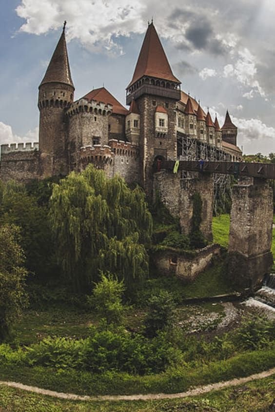 This may contain: an old castle sits on top of a hill