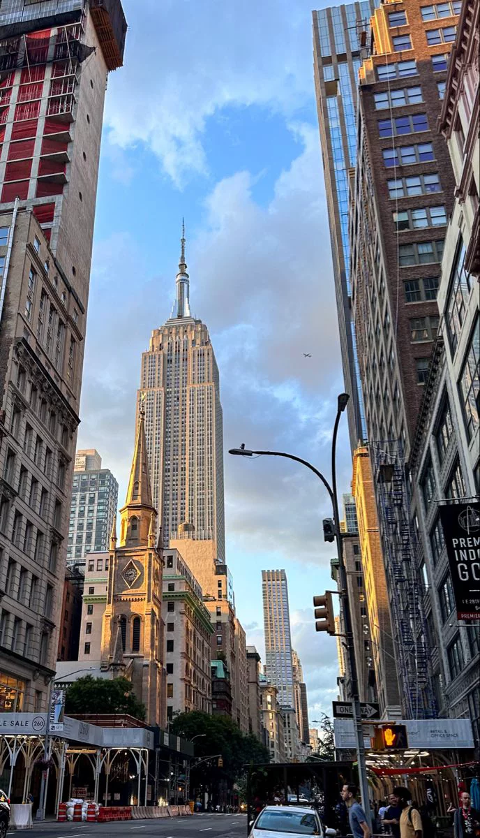 This may contain: a city street with tall buildings in the background