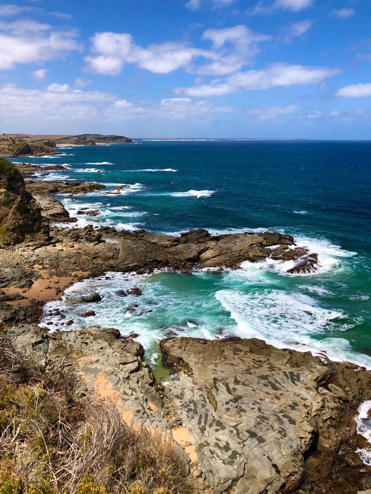 This contains: Views from cliff top with crashing waves on the rocks below.