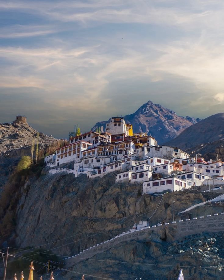 This may contain: a large white building sitting on top of a mountain