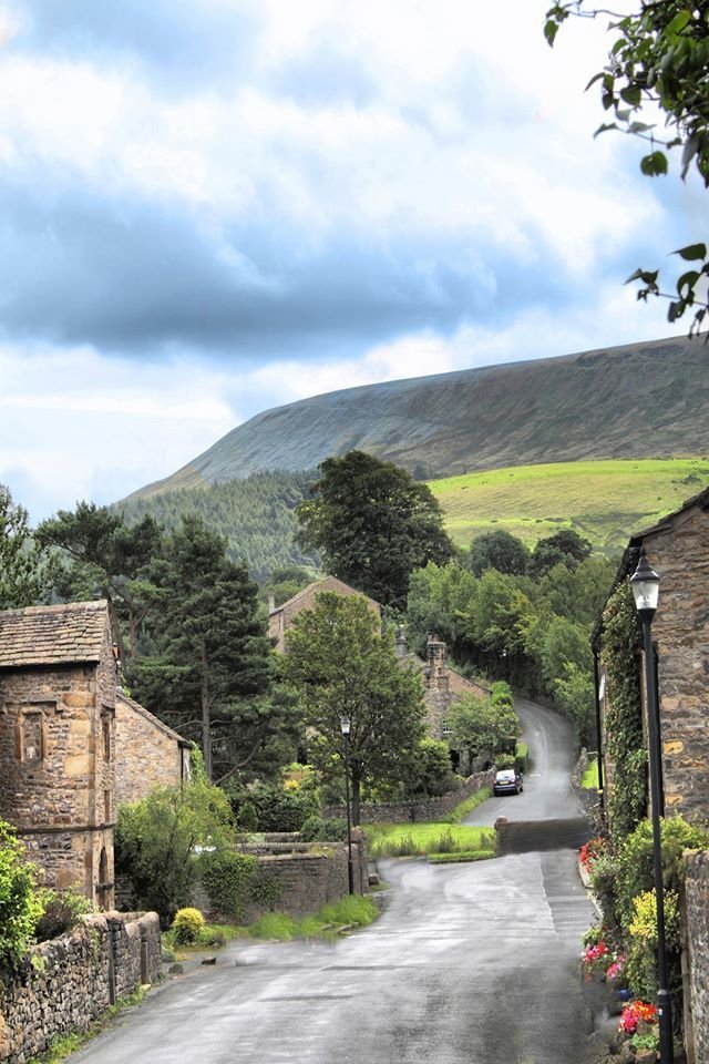 This may contain: an image of a road going through the country side with houses and trees on both sides