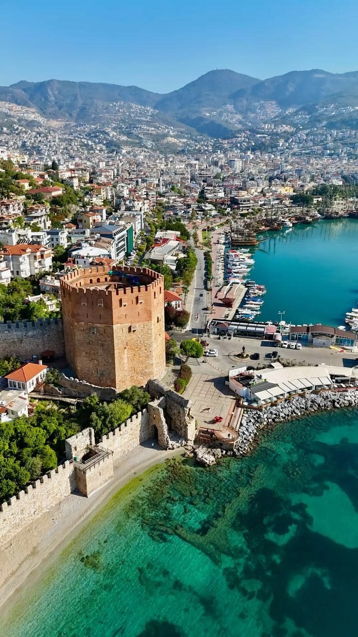 This may contain: an aerial view of the old city and its surrounding waterfront area, with clear blue water