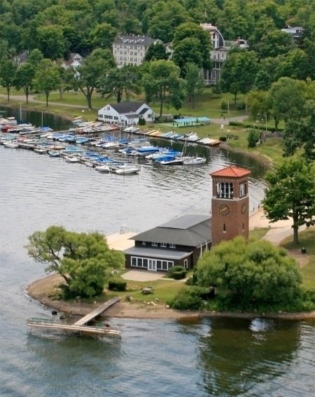 This may contain: an island with a clock tower on it in the middle of a body of water