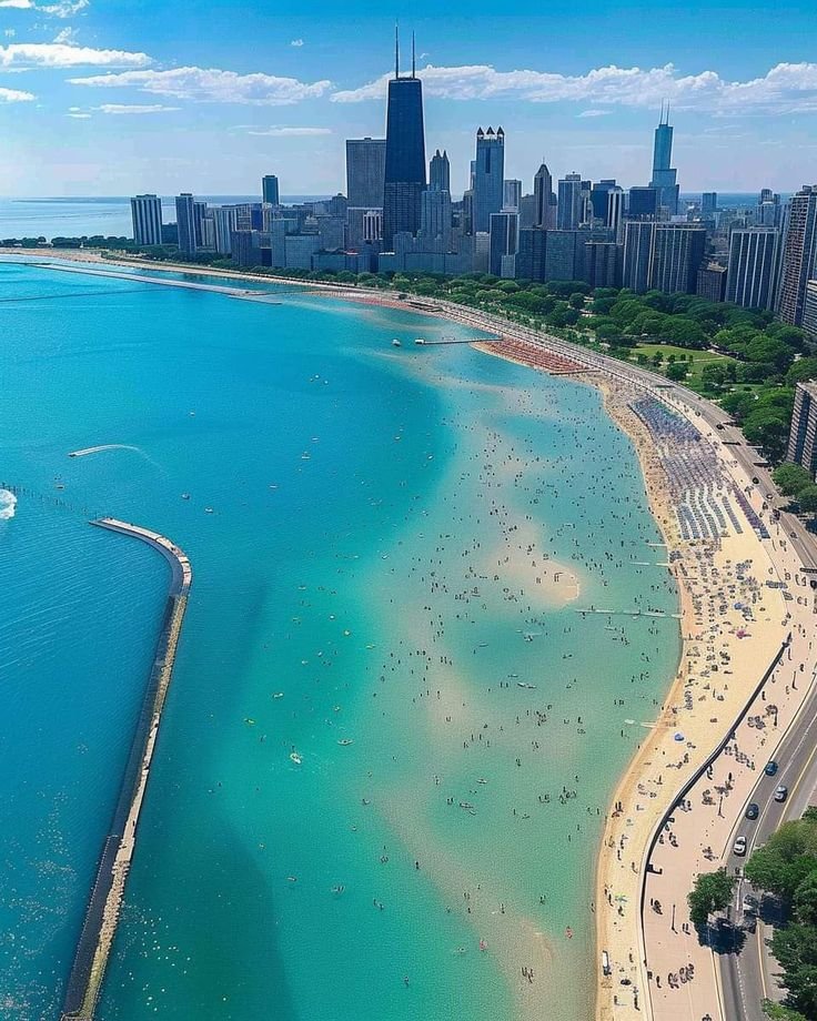 This may contain: an aerial view of the beach and city skyline in chicago, illinois on a sunny day