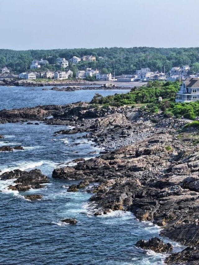 This may contain: houses on the coast line with water and trees