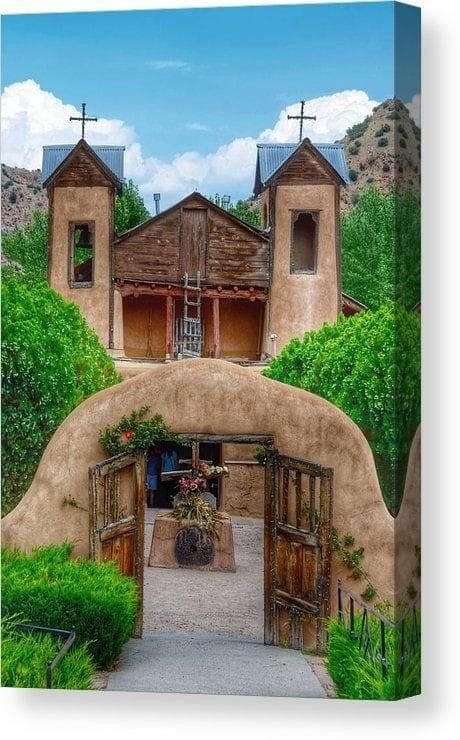 This may contain: an adobe style house with two crosses on the roof and three doors leading into it