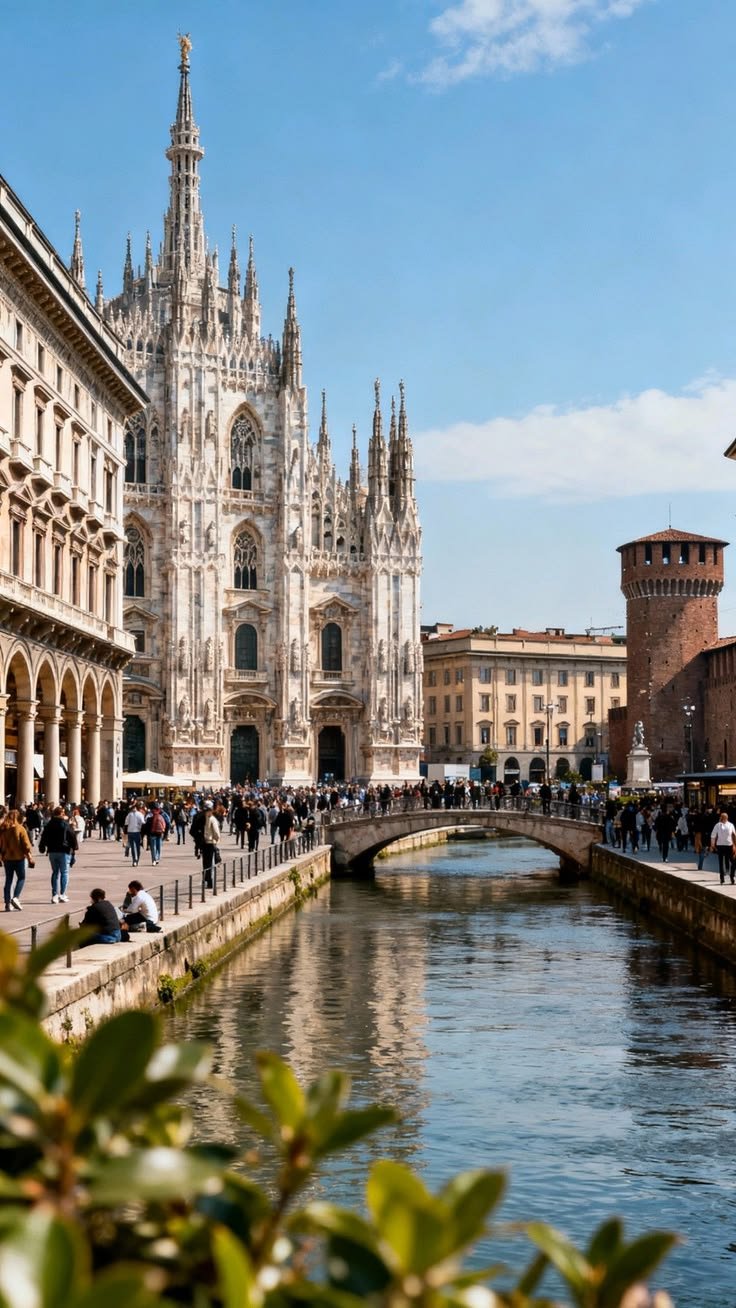 This may contain: people are walking along the river in front of an old building with towers and spires