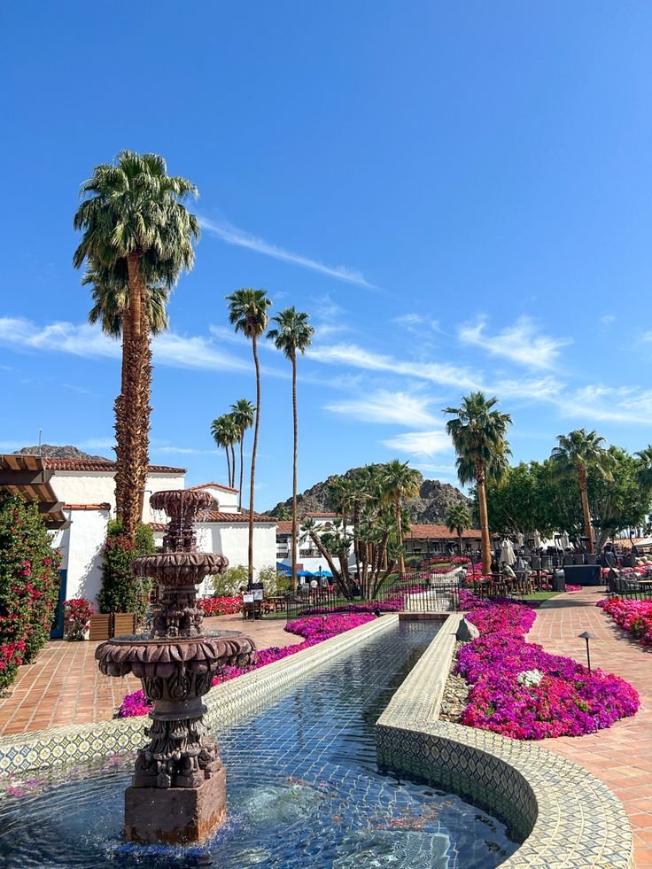 This contains: Palm springs california, La Quinta, Coachella Valley, bright flowers, Pink flowers, Palm trees, weekend getaway, trip, bachelorette hotel, views, hotel