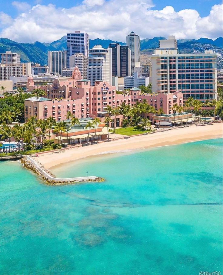 This may contain: an aerial view of the beach and buildings in waikiki, oahua