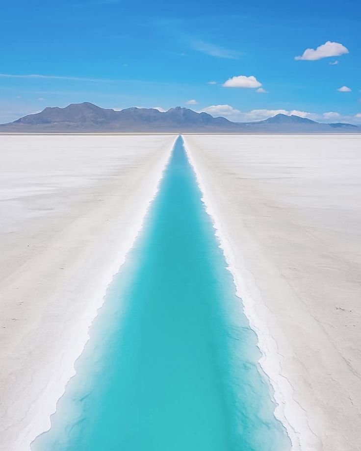 This may contain: a long stretch of blue water in the middle of nowhere