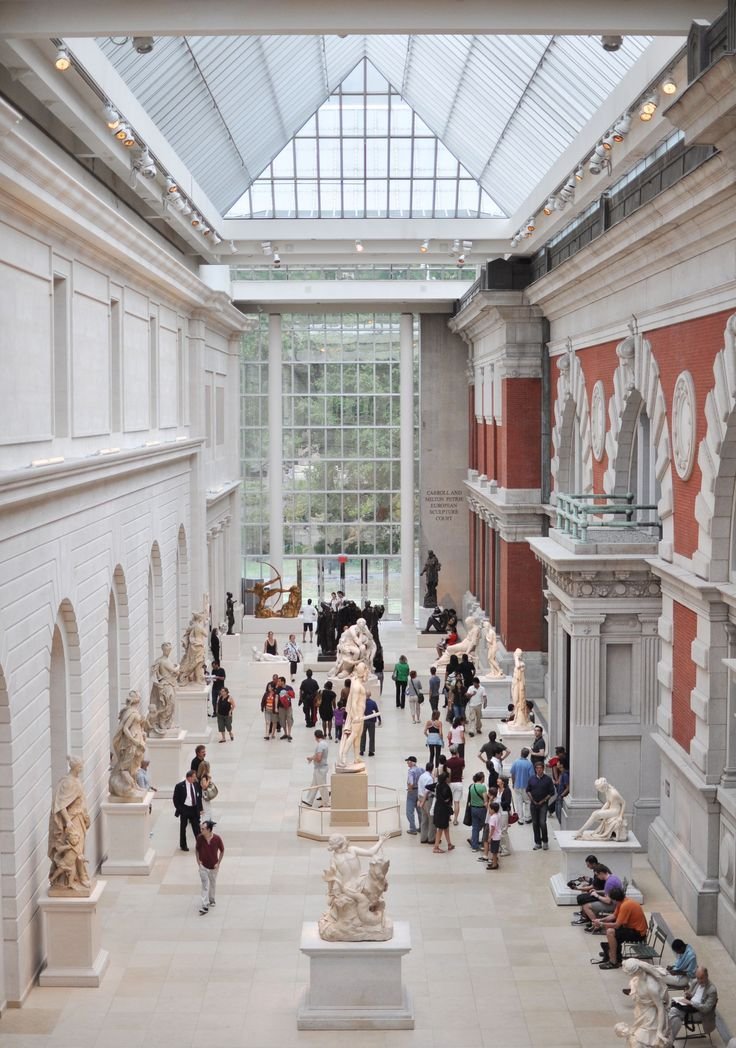 This may contain: the inside of a museum filled with lots of statues