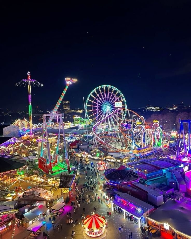 This may contain: an aerial view of a carnival at night