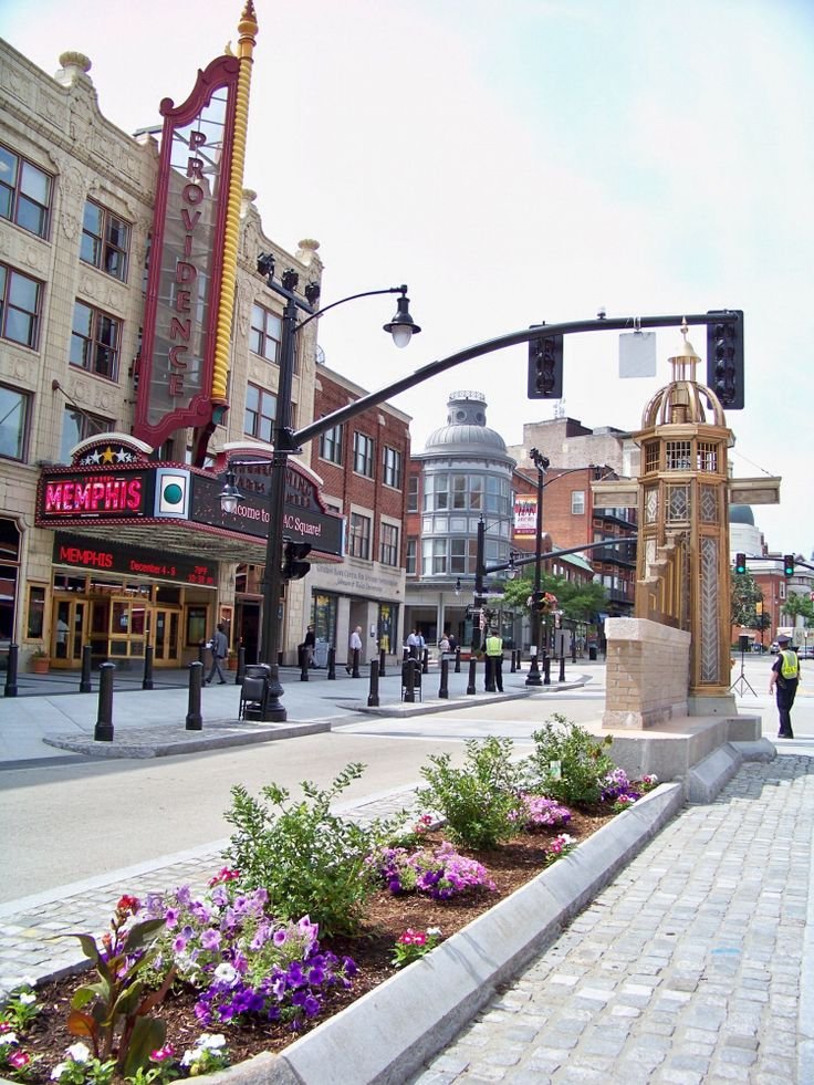This may contain: a city street filled with lots of traffic lights and flowers on the side of it