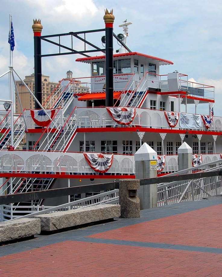 This may contain: a large red and white boat sitting on top of a pier