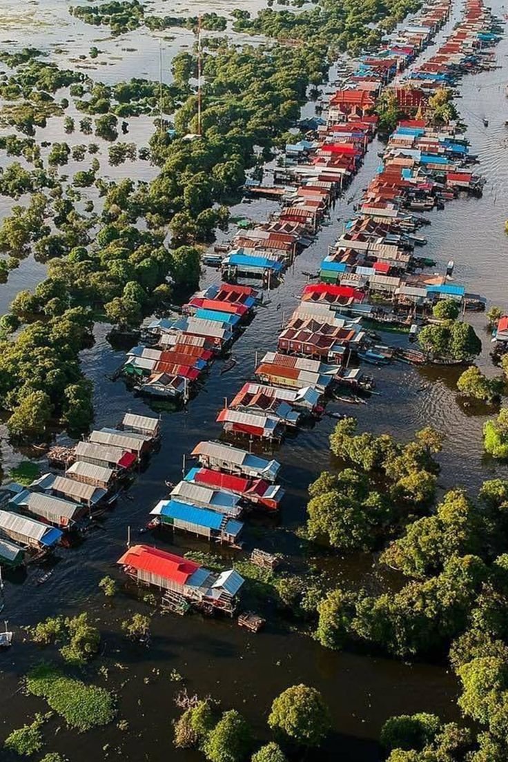 This may contain: many boats are docked in the water near some trees and land that is flooded with water