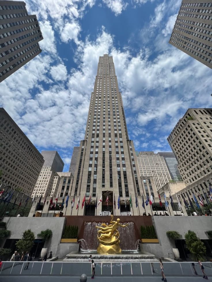 This may contain: looking up at the rockefeller building in new york city