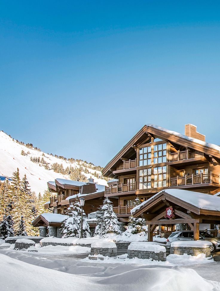 This may contain: a ski lodge with snow on the ground