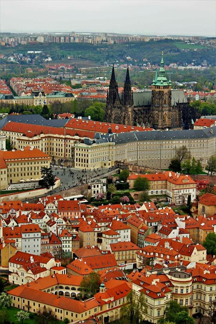 This may contain: an aerial view of a city with red roofs