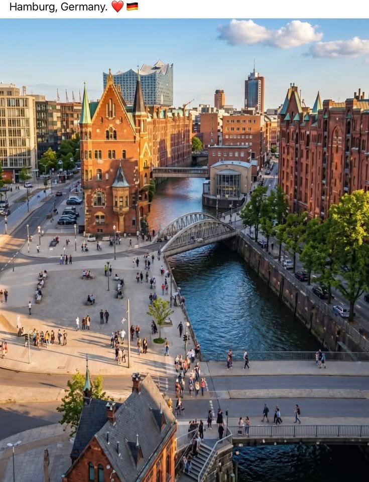This may contain: an aerial view of a city with people walking on the street and buildings in the background