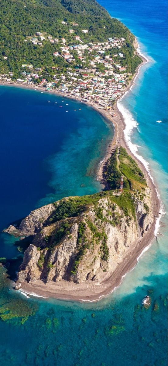 This may contain: an island in the middle of blue water