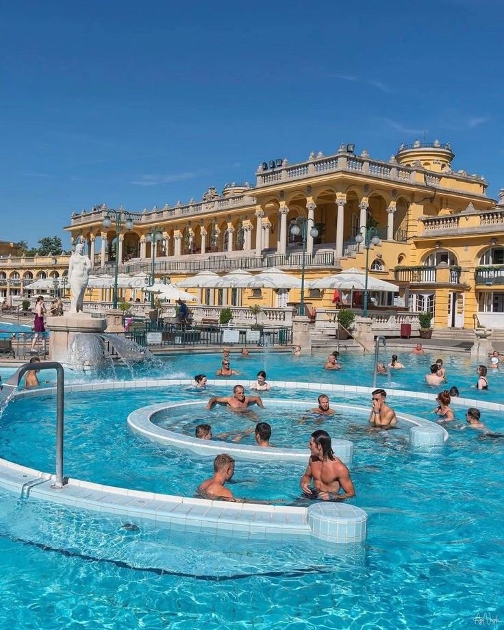 This may contain: many people are in the swimming pool