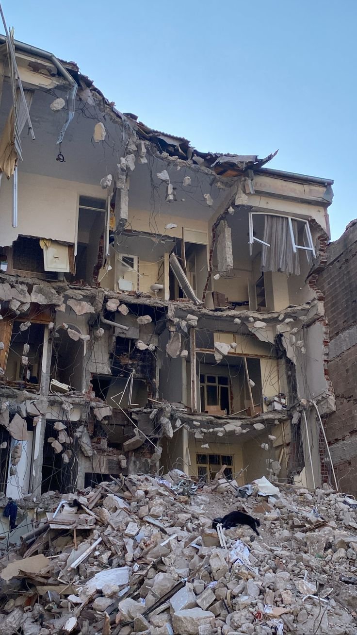 This may contain: a large pile of rubble next to a building