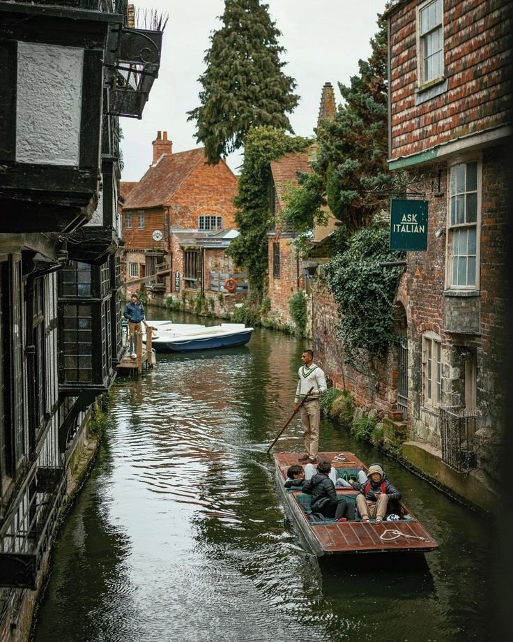This may contain: people are riding in a boat down the canal