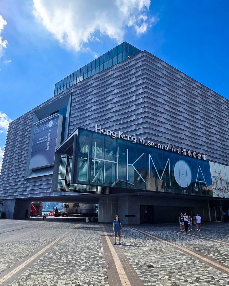 This may contain: people are standing in front of the museum of arts and design, which is on display at the hong kong museum of art