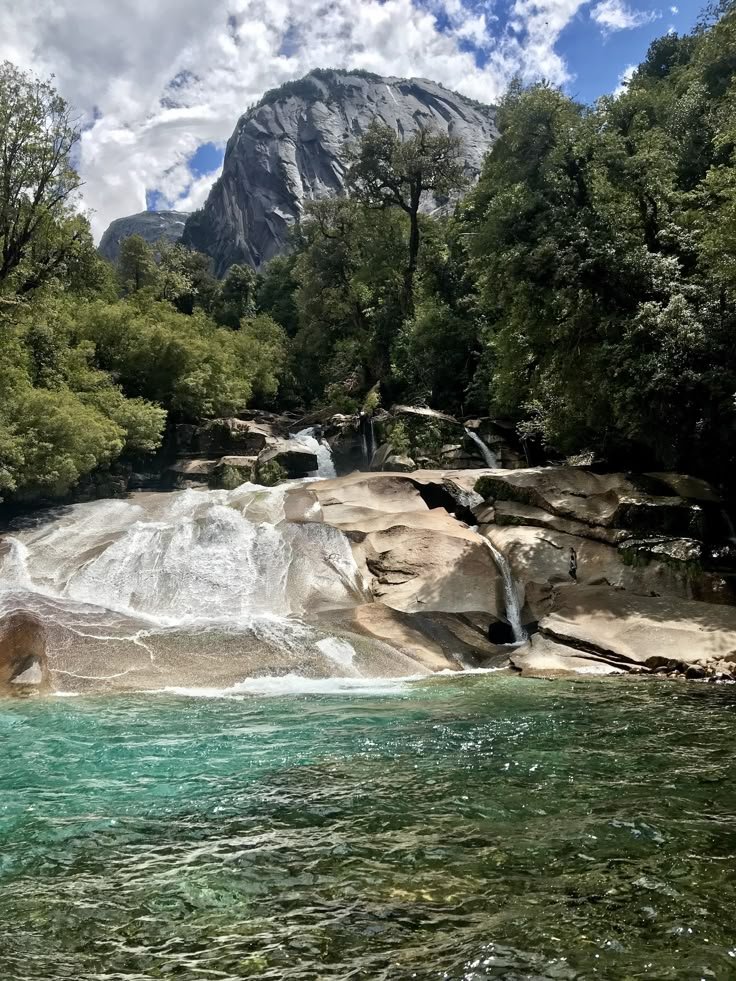 This may contain: there is a waterfall in the middle of some water