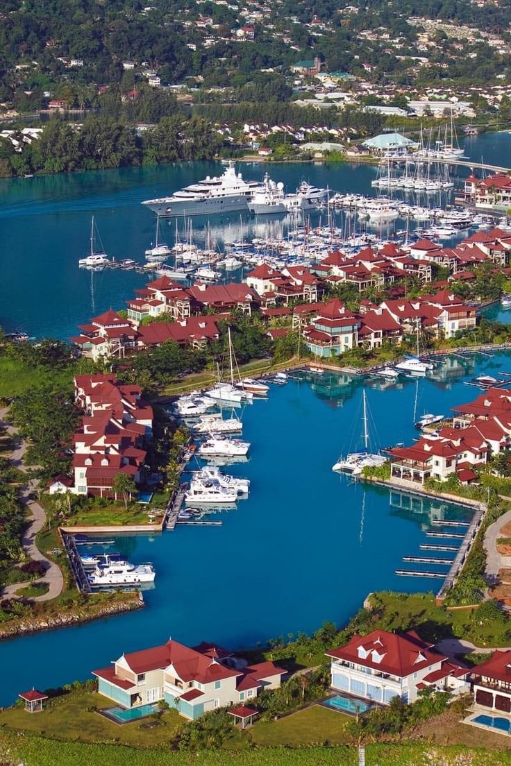 This may contain: an aerial view of a marina with boats and yachts