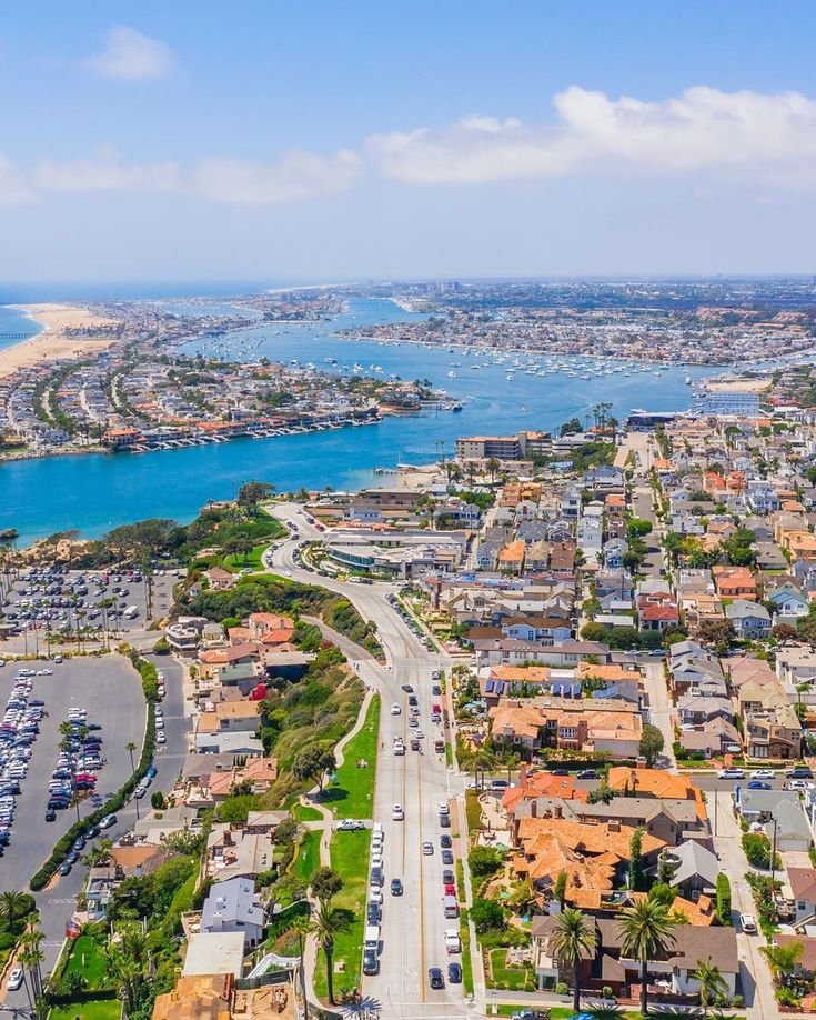 This may contain: an aerial view of a city and the ocean