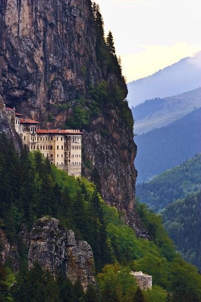 This may contain: an old castle perched on the side of a mountain