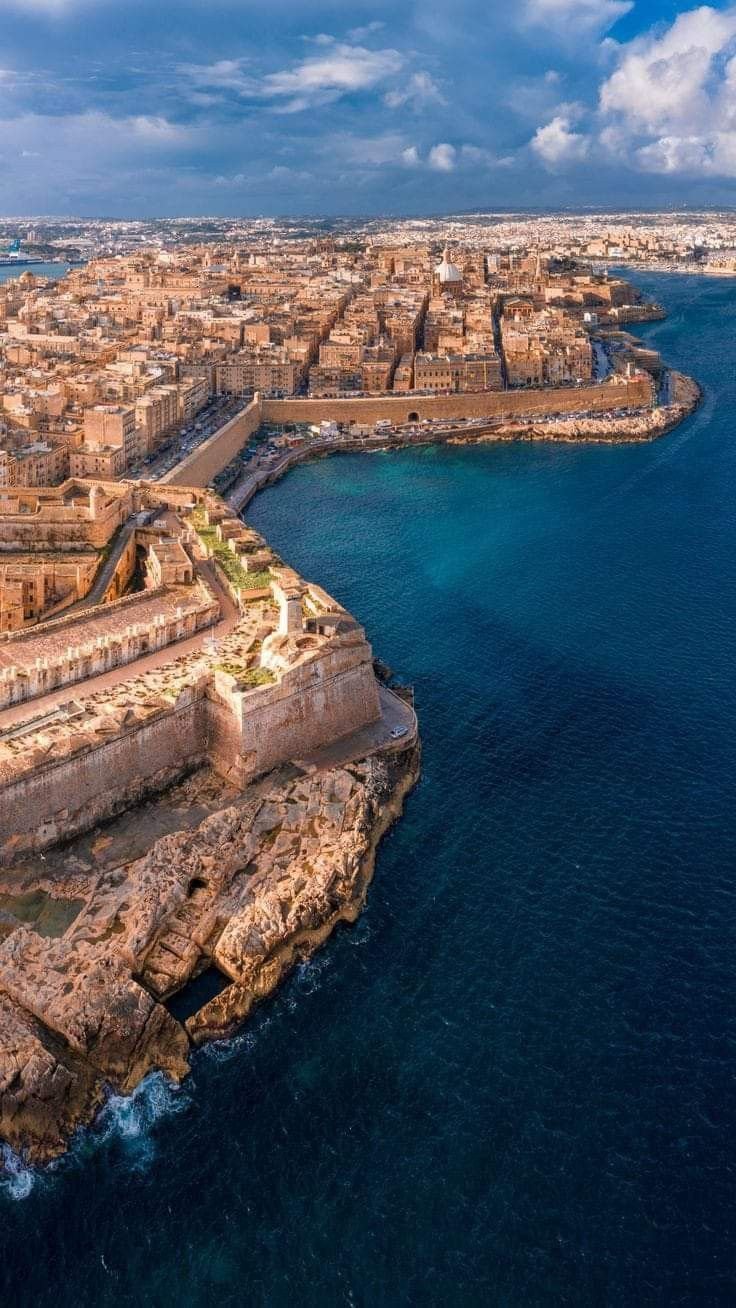This may contain: an aerial view of the coastline and city