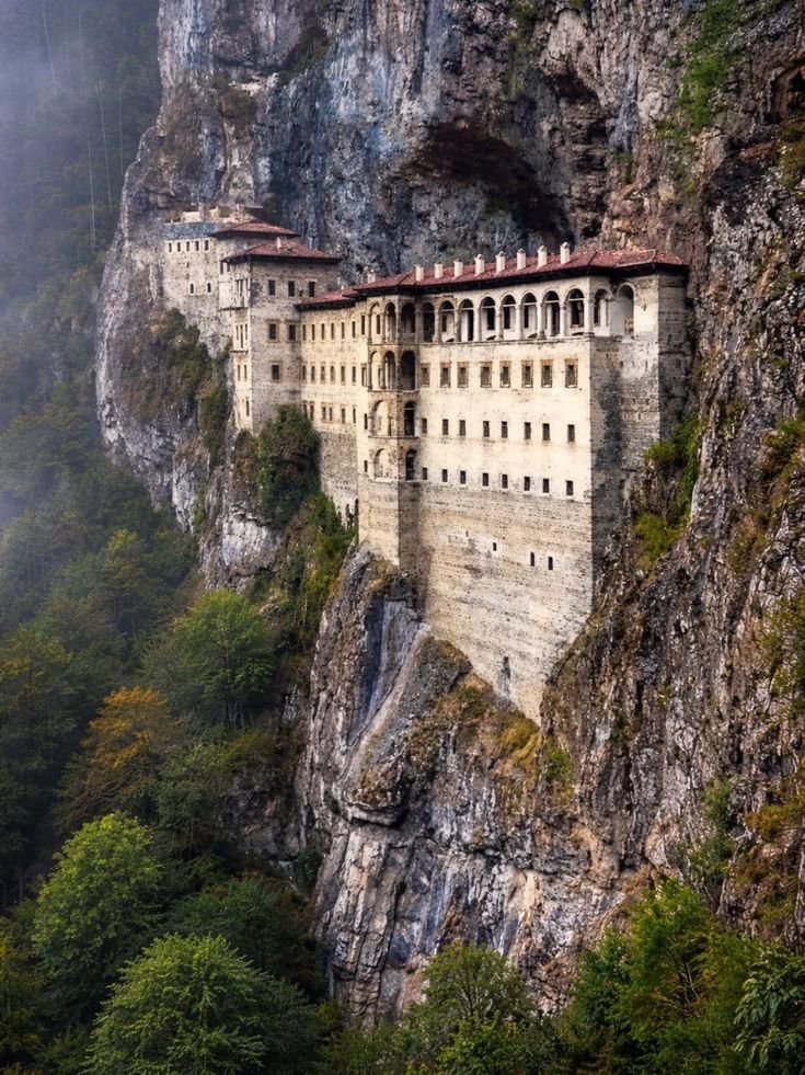This may contain: an old castle built into the side of a mountain