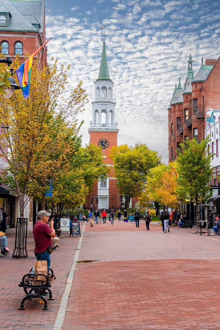 This may contain: a man sitting on top of a bench next to a clock tower