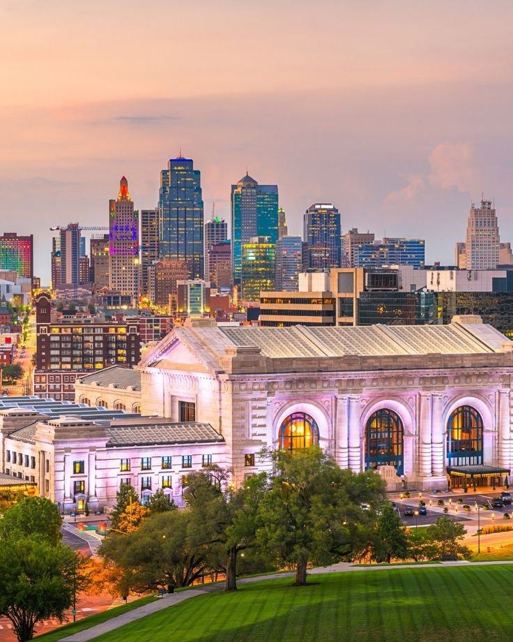 This may contain: the city skyline is lit up at night