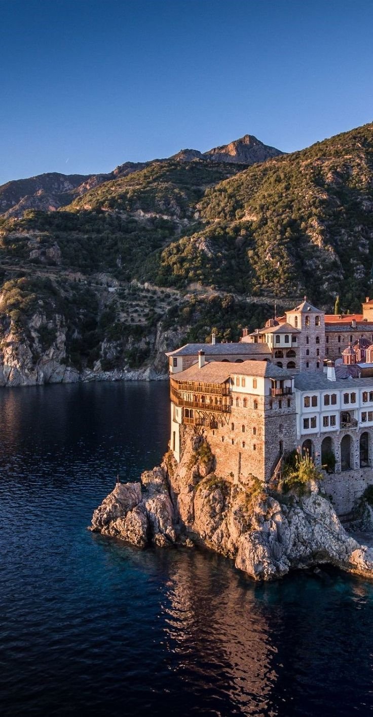 This may contain: an island in the middle of water with buildings on it