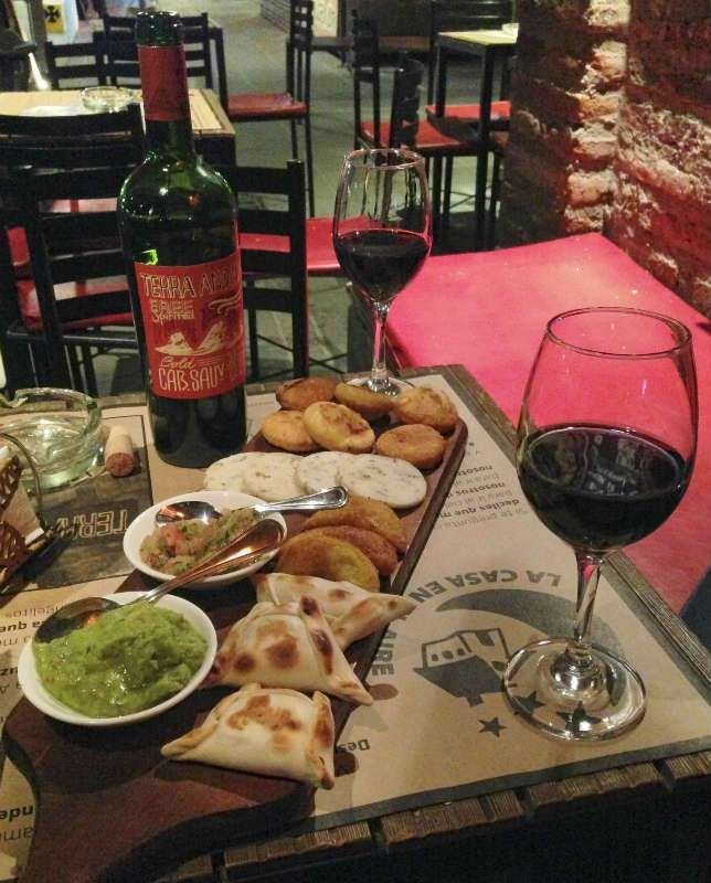 This may contain: food and wine on a table in a restaurant