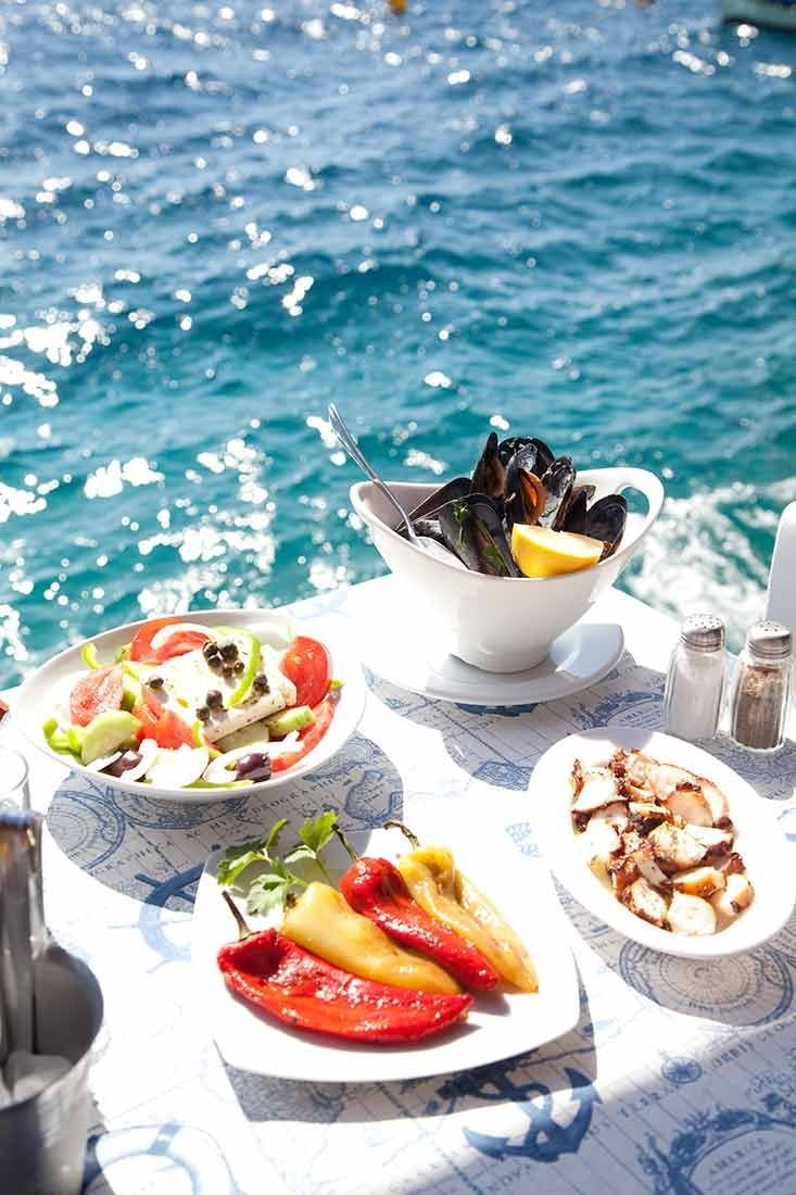 This contains: Lunch at Dimitris Ammoudi taverna, Oia, Santorini, Greece