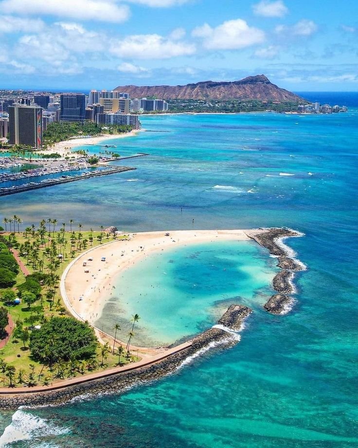 This may contain: an aerial view of the beach and ocean in waikiki, oahua
