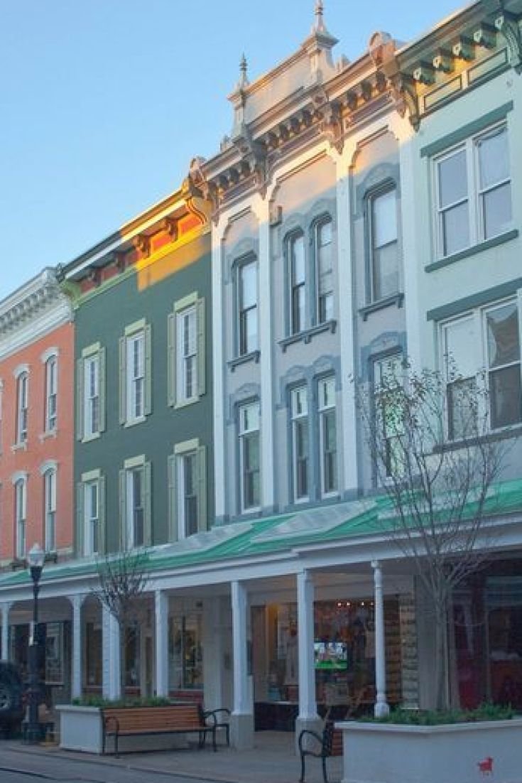 This may contain: several multi - colored buildings line the street in front of each other