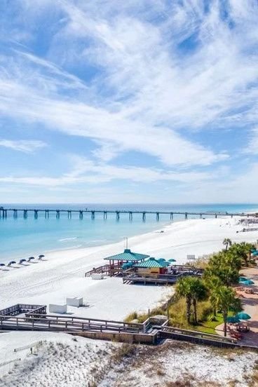 This may contain: an aerial view of the beach and boardwalks in destinia, florida usa
