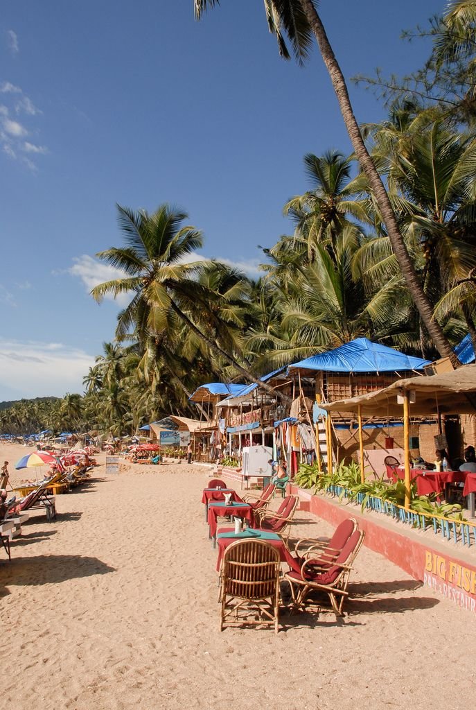This may contain: the beach is lined with chairs and umbrellas