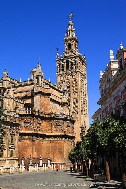 This may contain: an old building with a clock tower in the middle