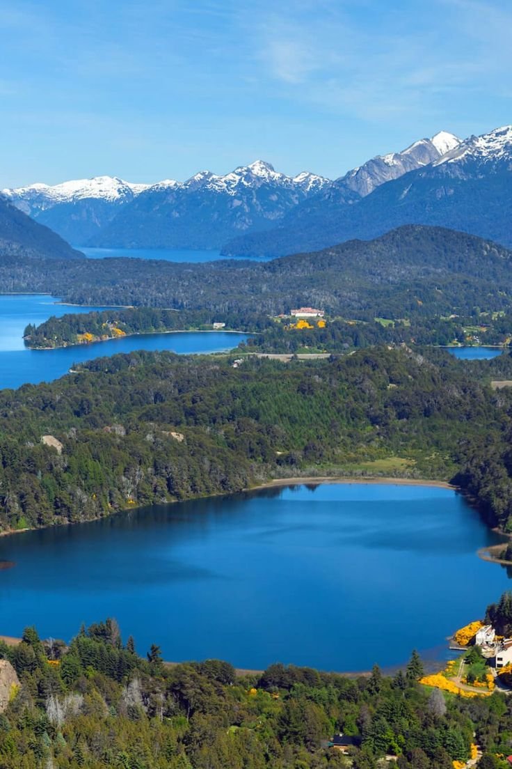 This may contain: an aerial view of a lake surrounded by mountains