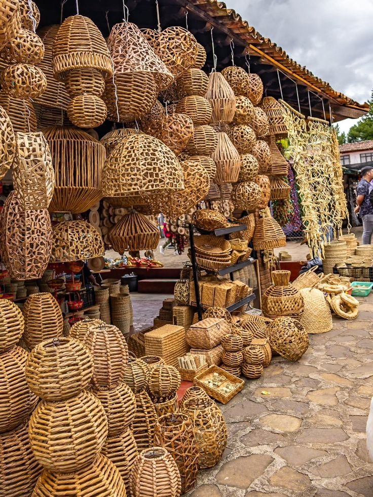 This may contain: baskets and other items for sale at an outdoor market