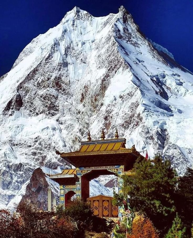 This may contain: the mountain is covered in snow and has a bell on it's roof,
