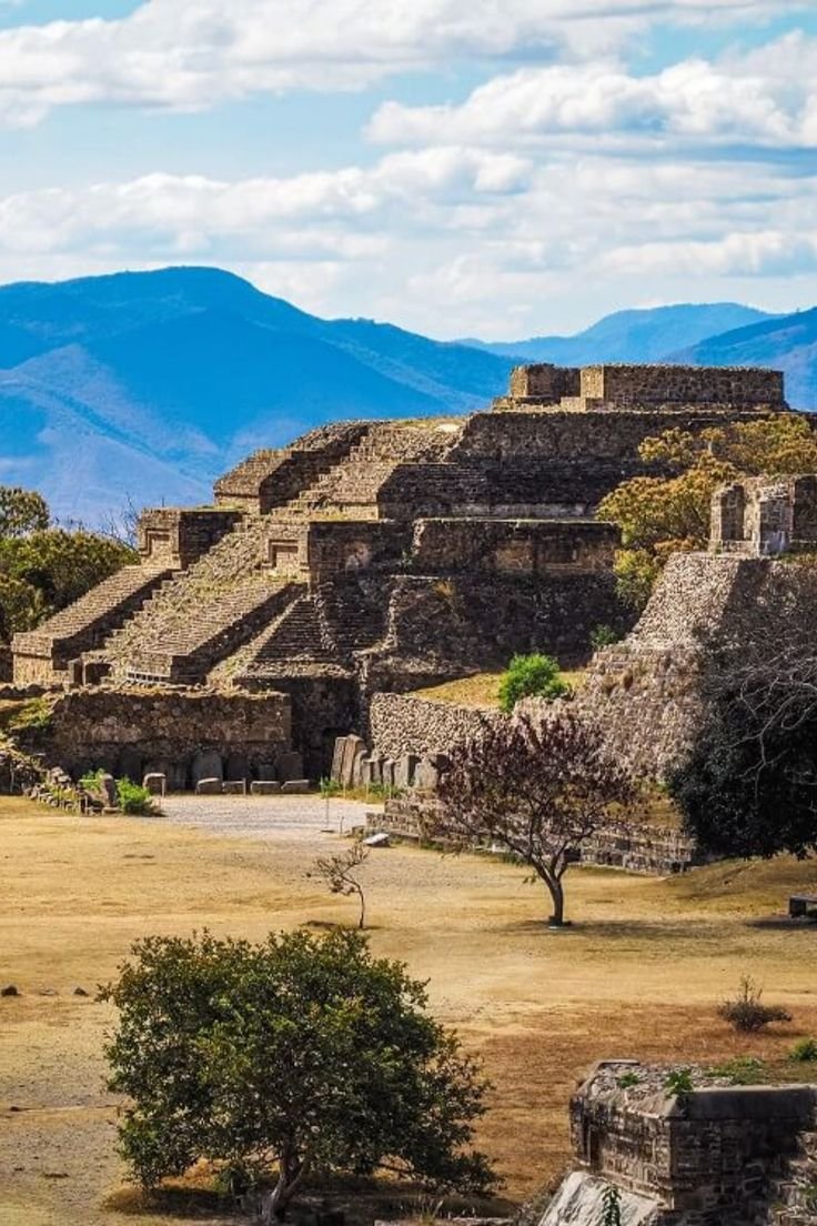 This may contain: an ancient city in the middle of nowhere with mountains in the backgrouds