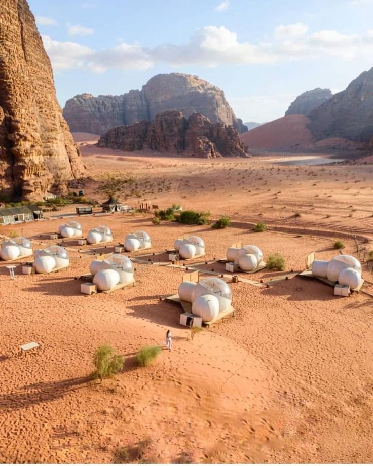 This may contain: there are many tents set up in the desert